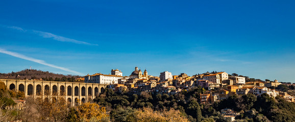 View of Ariccia, with the monumental bridge, the baroque Chigi palace and the church of Santa Maria Assunta by Gian Lorenzo Bernini. Castelli Romani, Lazio, Italy. - obrazy, fototapety, plakaty