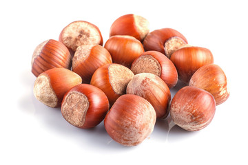 Pile of hazelnuts with shell isolated on white background.