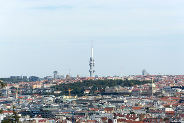 Prague panorama with colorful rooftops, with Zizkov television tower in the distance 
