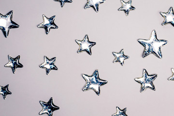 Shining silver stars on white background. Copy space.