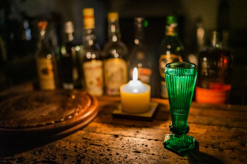 green glass with alcohol bottles