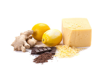ginger, lemon, cheese, grated cheese, chocolate, grated chocolate on a white background