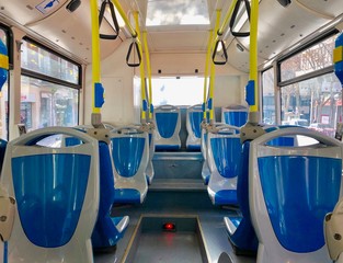 Interior of a bus with empty seats, blue and gray