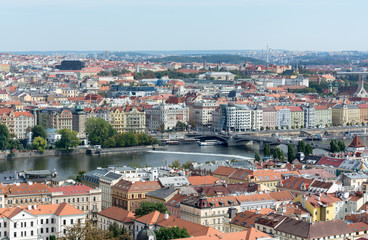 Fototapeta na wymiar Prague panorama with colorful rooftops, row of Vltava river waterfront buildings and Dancing house in view