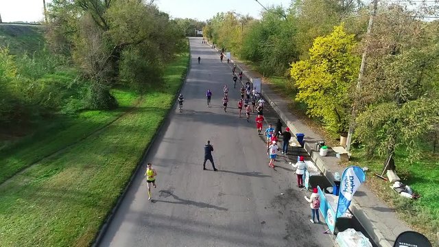 Zaporizhia  / Ukraine - 10.28.2018 Shooting athletes running under the quadcopter between the forest and the railway