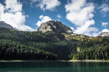 Black lake with water reflections at mountains of Montenegro, Durmitor