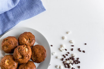 Photo of homemade muffins with bananas. Cooked muffins at home on a white background with a place for an inscription.