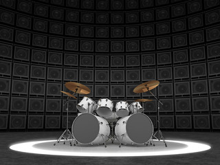 White drum set against the backdrop of a wall of guitar amps