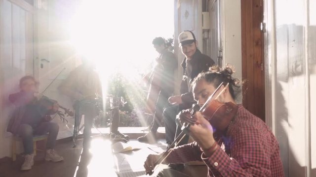 Students of a music school having a jam session on the hallway of an old house. Slow motion
