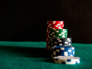 Several piles of poker chips of various colors