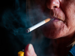 A mature woman smoking a cigarette