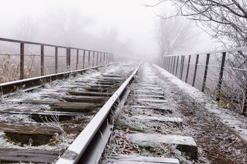 Rails in hoarfrost. Misty autumn morning.