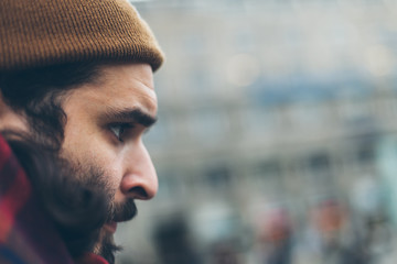 Man with beard and mustache fall and winter season. Hipster cool, sexy, handsome young guy. Real people concept. Male urban trendy hat, scarf and coat.