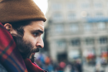 Man with beard and mustache fall and winter season. Hipster cool, sexy, handsome young guy. Real people concept. Male urban trendy hat, scarf and coat.