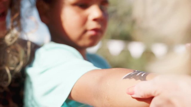 Close Up Slow Motion Shot Of Young Boy With Mother At Face Painting Stall At Summer Garden Fete