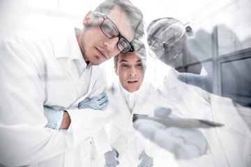 close up.a group of scientists discussing the results of the experimen