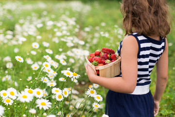 Girl with basket of strawberries