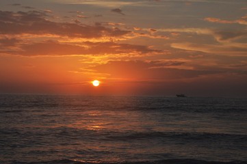 Sunset over the ocean with boat
