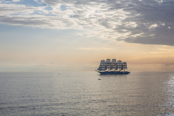 Sailing boat at horizon in Alghero Italy