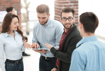 Business team with tablet pc computer having discussion in offic