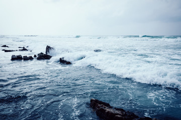 Fototapeta premium sea waves breaking on seashore rocks