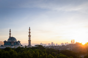 Fototapeta na wymiar Federal Mosque view during the sunrise with Kuala Lumpur Cityscape