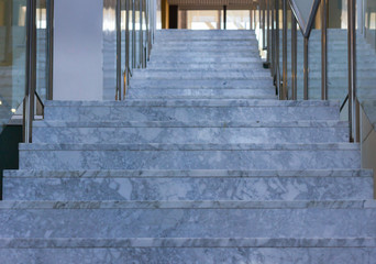 Grey marble flooring stairs from below inside hospital building. Going up, increase, growth, adversity, goals, difficulty concepts