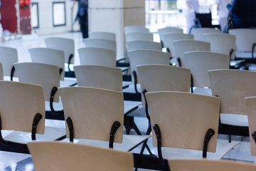 Empty white seats in hospital waiting room. Public health care access concept