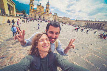 Happy young man taking a selfie photo in Bogota, Colombia. in the main square of the city called...