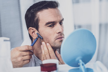 Serious model taking care of his face