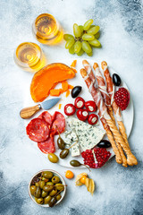 Appetizers table with antipasti snacks and wine in glasses. Authentic traditional spanish tapas...