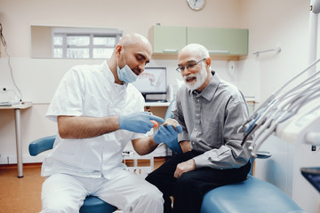 Fototapeta premium Old man sitting in the dentist's office