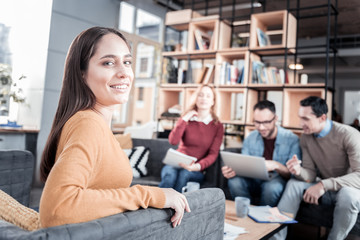 Joyful woman working with his team