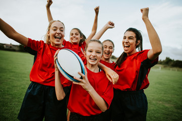 Cheerful female rugby players celebrating