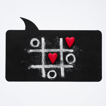 Valentines day background with heart. Valentines day concept with hearts X-O game. Tic tac toe game concept. View from above