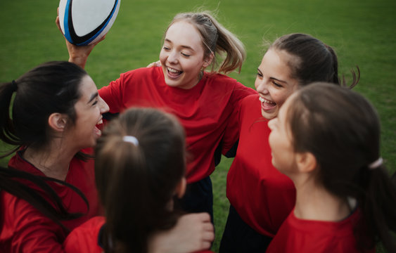 Cheerful young rugby players on the field