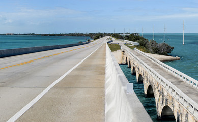 Overseas Highway:  A modern bridge passes beside its older counterpart (now a fishing pier) as US Route 1 connects the Florida Keys and divides the Atlantic Ocean from the Gulf of Mexico.