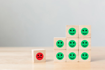 Wooden block with icon face emotion happiness and sadness, Unique, think different, individual and...