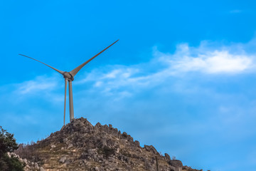 View of a wind turbine on top of mountains