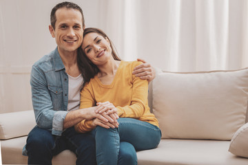 Smiling couple feeling happy while planning childbirth