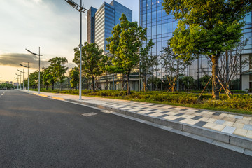 Fototapeta na wymiar Empty asphalt road through modern city in Shanghai, China
