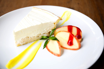 Coconut cake on white plate on table