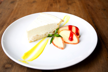 Coconut cake on white plate on table
