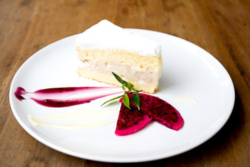 Coconut cake on white plate on table