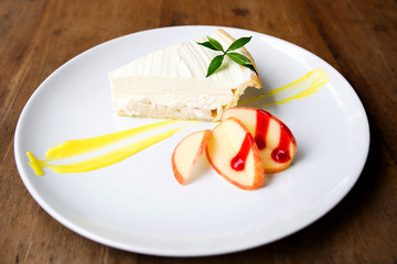 Coconut cake on white plate on table