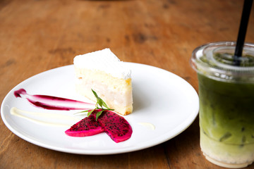 Coconut cake on white plate on table