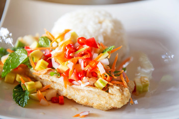 Soft rice and grilled fish Dolly bento with vegetables, selective focus.