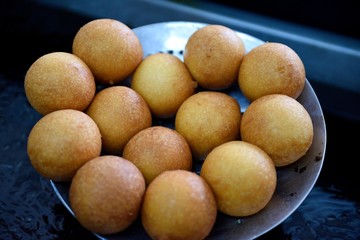 Several hot freshly made Colombian Bunuelos, or fried cheese fritters in Colombia, South America