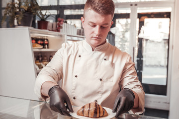 Chef finishing the serving of the croissant