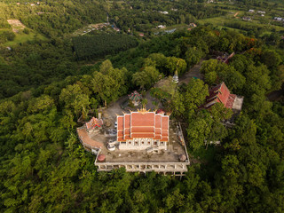 Aerial view of Wat Phra That Doi Khao Kwai located on the small mountain peak in Chiang Rai province of Thailand. This place is the best spot for see panoramic view of Chiang Rai cityscape.